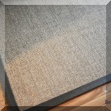 D26. Ribbon bound sisal rug. Approx. 8' x 10' 